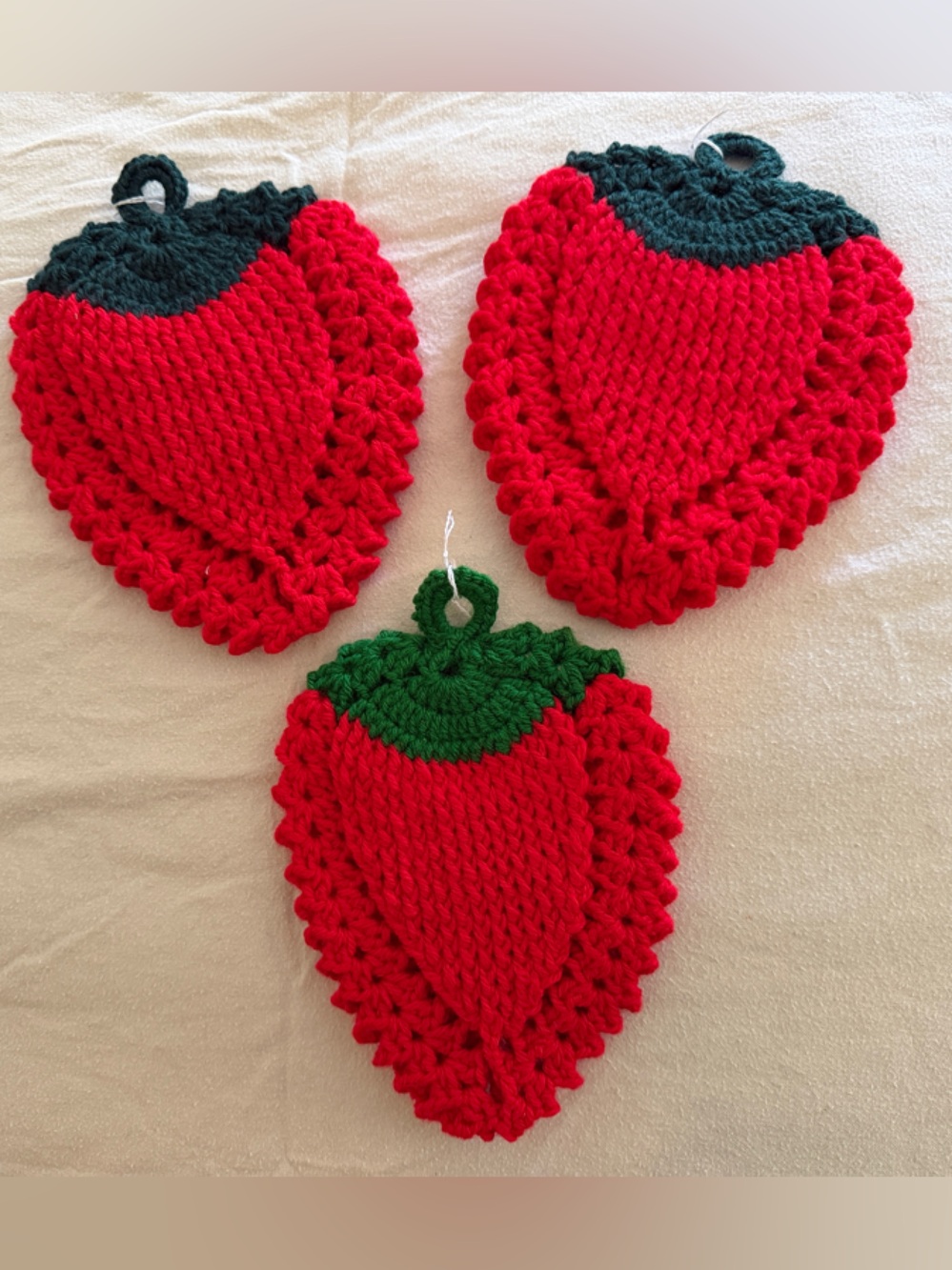 Three Handmade Red Crochet Strawberry Pot Holders with Green Tops